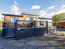 A house with a deck and stairs at 7 Lake View, Lake View 7, White Cross Bay near Windermere