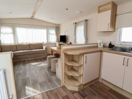 A living room with a couch and table at E10 Static Caravan in Rhyl