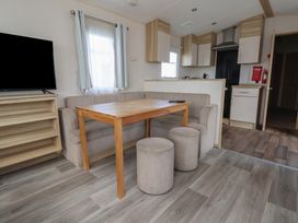A living room with a sofa and table at A5 Static Caravan Rhyl