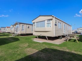 A static caravan with steps and outdoor seating at A5 Static Caravan in Rhyl