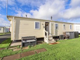 A caravan with steps and bench at Chappie's Caravan - Rhyl 8 Rhyl