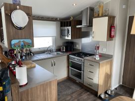 A kitchen with appliances and utensils at 5 Rush Grove Caravan in Leven