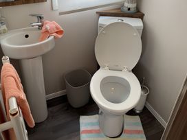 A sink and toilet in a bathroom at 5 Rush Grove Caravan Leven