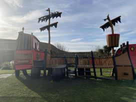 A pirate ship playground structure in an outdoor play area at 5 Rush Grove Caravan Leven