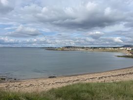 A beach view with sand and water at 5 Rush Grove Caravan in Leven