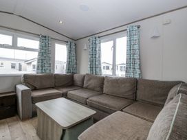 A living room with a sofa and coffee table at Caravan - 2 Bayside Watchet