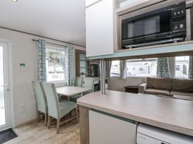A dining room with a table and chairs at Caravan - 2 Bayside in Watchet