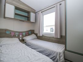 A bedroom with two beds and a window at Caravan - 2 Bayside in Watchet