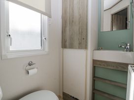 A bathroom with a toilet and sink at Caravan - 2 Bayside in Watchet
