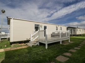 A caravan with a deck and pathway at Caravan - 2 Bayside Watchet