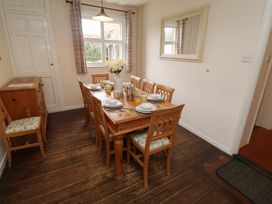 A dining room with a large table set for breakfast at Duke Cottage in Woodbridge