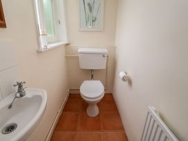 A bathroom with a toilet and sink at Duke Cottage in Woodbridge