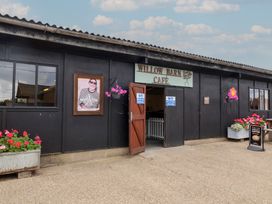 An entrance to Willow Barn Café with flowers at the front at Duke Cottage in Woodbridge