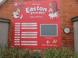 A sign with schedule and clock at Easton farm park in Woodbridge