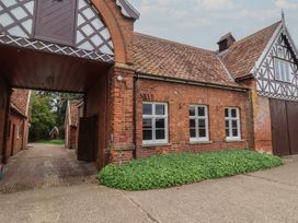 An outdoor view of a brick building with arched entrance at Duchess Cottage in Woodbridge