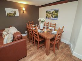 A dining room with a table set for meals at Duchess Cottage in Woodbridge
