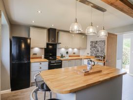 A kitchen with a refrigerator and oven at Rushmoor Cottage in Colaton Raleigh