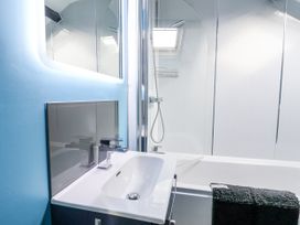 A bathroom with a sink and shower at Rushmoor Cottage in Colaton Raleigh