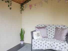 A snug with a sofa and plant in Rushmoor Cottage Colaton Raleigh