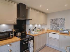 A kitchen with a stove and sink at Rushmoor Cottage in Colaton Raleigh