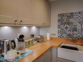 A kitchen with appliances and a sink at Rushmoor Cottage in Colaton Raleigh