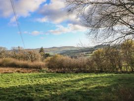 A landscape view with hills and trees at 1 Fron Uchaf Parc near Bala