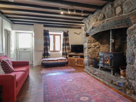 A living room with a sofa and fireplace at 1 Fron Uchaf in Parc near Bala