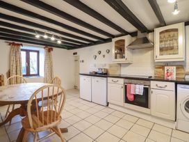 A kitchen with a table and chairs at 1 Fron Uchaf in Parc near Bala
