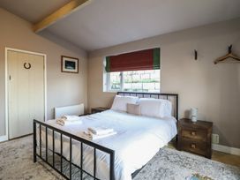 A bedroom with a bed and bedside tables at 1 Fron Uchaf in Parc near Bala