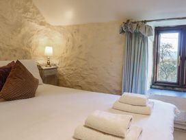 A bedroom with a bed and lamp at 1 Fron Uchaf in Parc near Bala