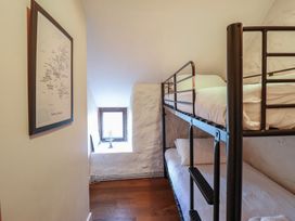 A bedroom with a bunk bed and a window at 1 Fron Uchaf in Parc near Bala