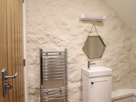 A bathroom with a sink and towel radiator at 1 Fron Uchaf Parc near Bala