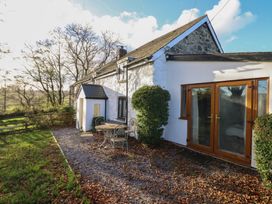 A house with a table and chairs outside at 1 Fron Uchaf in Parc near Bala