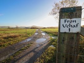 A dirt path with a gate and signpost at 1 Fron Uchaf in Parc near Bala