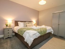 A bedroom with a bed and a bedside table at Klysa in Camborne