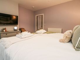 A bedroom with a bed and television at Klysa in Camborne