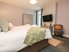 A bedroom with a bed and television at Klysa in Camborne