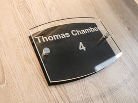A sign displaying Thomas Chambers and room number 4 at Thomas Chambers in Camborne