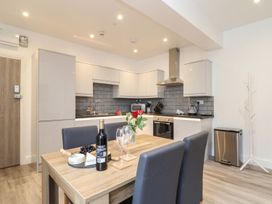 A kitchen with a dining table and appliances at West Chambers in Camborne