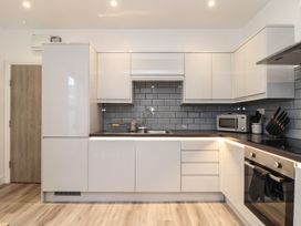 A kitchen with a sink, microwave, and oven at West Chambers in Camborne