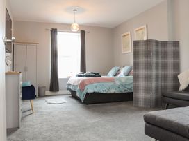 A bedroom with a bed and wardrobe at West Chambers in Camborne