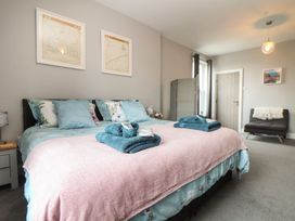 A bedroom featuring a bed with pillows and a throw blanket at West Chambers in Camborne