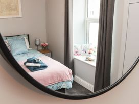A bedroom with a bed and window at West Chambers in Camborne