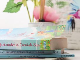 A stack of books with flowers in a pot at West Chambers in Camborne