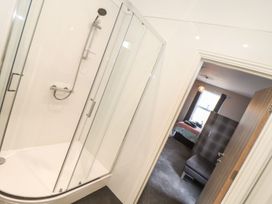 A bathroom with a shower and a view of a bedroom at West Chambers in Camborne