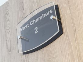 A wall sign displaying West Chambers and the number 2 at West Chambers in Camborne