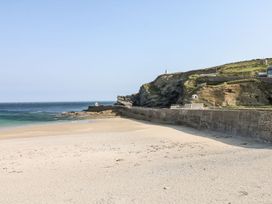 A beach with cliffs and water at West Chambers in Camborne