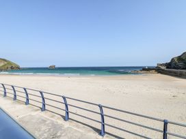 A beach scene with water and sand at West Chambers in Camborne