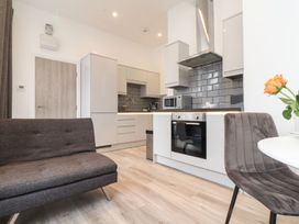 A kitchen with cabinets and appliances at Baker Chambers in Camborne