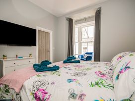 A bedroom with a bed and television at Baker Chambers in Camborne